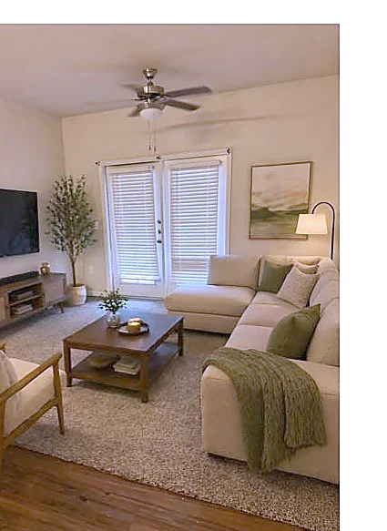 Bright, comfortable living room with ceiling fan, sofa, and large windows at Kenedy Heights